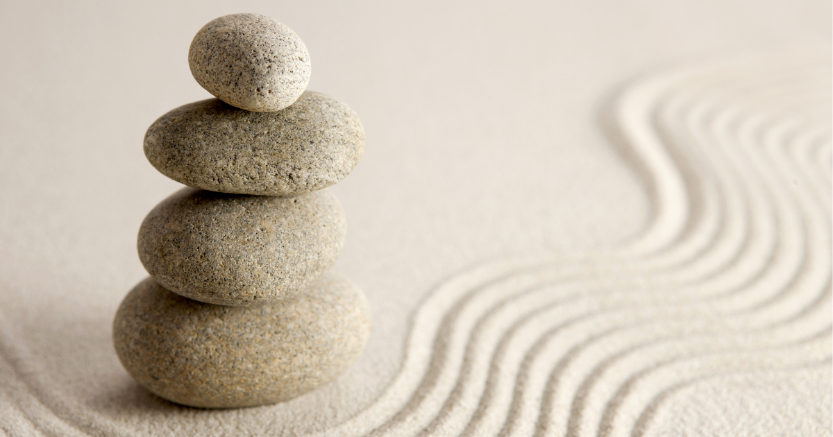 Stones stacked on sand.