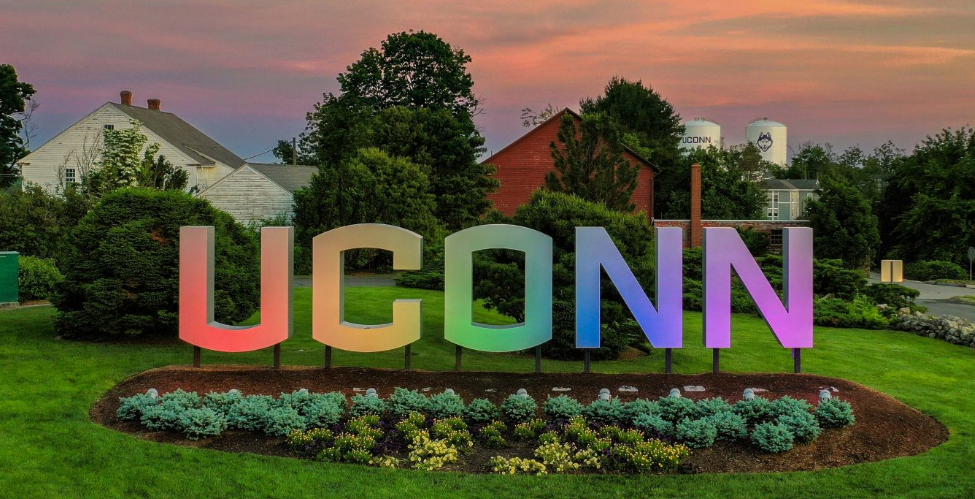 The UConn gateway sign lit in rainbow colors in observance of LGBTQIA+ pride month. (Sean Flynn/UConn Photo)