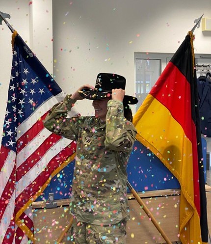 Photo of Army Officer Caleigh Heske between the American and German Flag